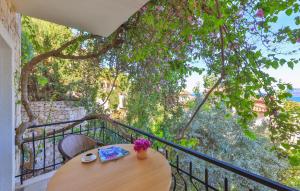 a wooden table on a balcony with a tree at Hill House Adult Only in Kaş