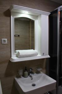 a bathroom with a sink and a mirror at Exceptional Accommodation in Čačak