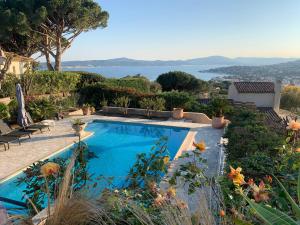 a swimming pool with a view of the water at Villa les Cades in Sainte-Maxime