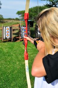 a woman is holding a baseball bat at Sondela Nature Reserve & Spa Makhato Lodges in Bela-Bela