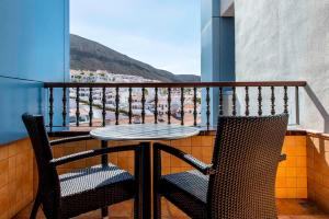 a table and two chairs on a balcony with a view at Paradise Park Fun Lifestyle Hotel in Los Cristianos