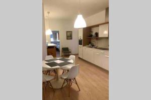 a kitchen and dining room with a table and chairs at Acogedor apartamento en Ruzafa-centro in Valencia