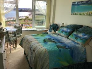a bedroom with a bed with a view of the ocean at Vista Room with a Sea View in Paignton