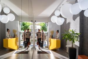 a group of people standing in a lobby at Thess Residences in Thessaloniki