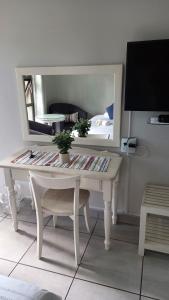 a white desk in a room with a mirror at Harmony Guesthouse in Nelspruit