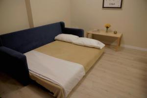 a bedroom with a bed and a side table at RecoBerta Studio. Vivir Recoleta!! in Buenos Aires