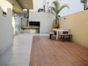 a large empty room with a table and benches at RecoBerta Studio. Vivir Recoleta!! in Buenos Aires