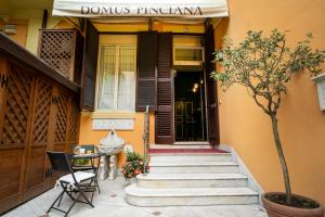 a house with a staircase leading to the front door at Domus Pinciana in Rome +1 photo