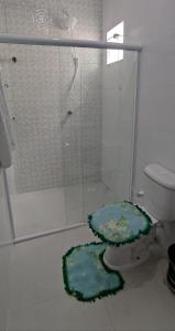 a bathroom with a toilet with a glass shower at Casa do Lamarques in Piranhas