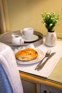 a table with a plate with a pastry on it at Domus Pinciana in Rome