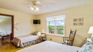 a bedroom with two beds and a window at Bayview Pines Country Inn B&B in Mahone Bay
