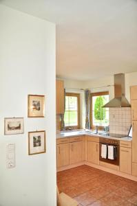 a kitchen with wooden cabinets and a stove at Sonnenapartment in Going
