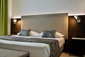 a hotel room with a large bed with two pillows at Elite Hotel & Spa in Mestre