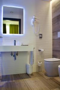 a bathroom with a sink and a toilet and a mirror at Elite Hotel & Spa in Mestre