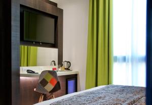 a hotel room with a bed and a television at Elite Hotel & Spa in Mestre
