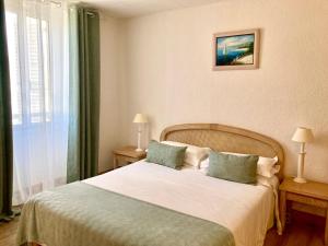 Postel nebo postele na pokoji v ubytování Hotel la Caravelle