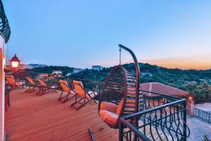 a group of chairs sitting on the deck of a house at Hill House Adult Only in Kaş