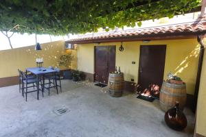 an outdoor patio with a table and two wine barrels at Healthy House Glamping in Koper