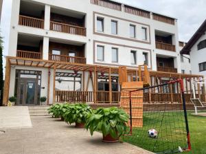 an apartment building with a goal in front of it at Sim House in Gura Humorului