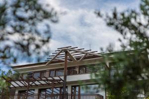 a house with a wooden pergola on top of it at Cherry Villa in Sozopol