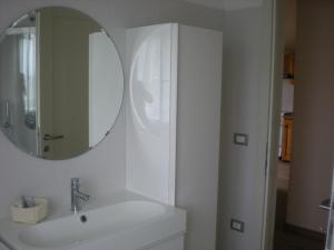 a white bathroom with a sink and a mirror at Villa Ducati in Vattaro +20 photos