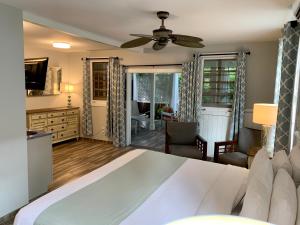a bedroom with a bed and a living room at Douglas House Adult Only in Key West