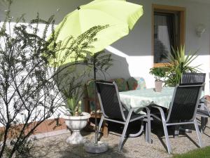 a table and chairs with a yellow umbrella at Haus Daniel in Neustift im Stubaital