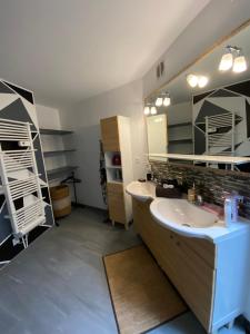 a bathroom with a sink and a mirror at Au cœur du Sénéchal in Marquise +41 photos