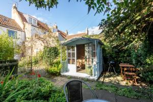 a greenhouse in the garden of a house at The Cooperage - 2 Bedroom, 2 Bathroom with Garden in Crail