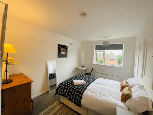 a bedroom with a bed and a window at Golden Triangle House in Norwich