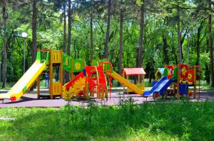 a playground with colorful slides in a park at Апартаменты Park & House 42 на 5 гостей рядом с Источником и парком in Essentuki