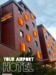 a building with neon signs on the side of it at Antony Hotel - Venice Airport in Campalto