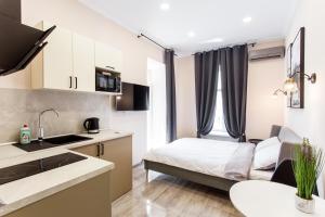 a small apartment with a bed and a kitchen at Havana ApartHotel in Odesa