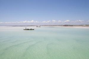 a boat in the middle of a large body of water at Billionaire Resort & Retreat Malindi in Malindi