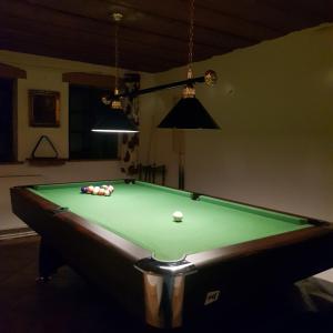 a pool table with balls on it in a room at Dom Zielony Kamień z jacuzzi i bilardem in Szklarska Poręba