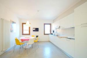 a kitchen with a table and chairs in a room at DolceVita Apartments N. 491 Biennale in Venice