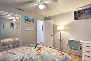 a bedroom with a bed and a ceiling fan at Hot Tub and Theater Room Tropical Springfield Home in Springfield