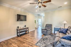a living room with two couches and a flat screen tv at Recently Built Oak Island House with Golf Cart! in Oak Island