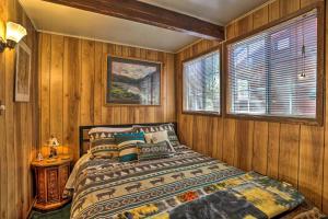 een slaapkamer met houten wanden, een bed en een raam bij One-Of-A-Kind Couples Getaway Big Bear A-Frame! in Sugarloaf