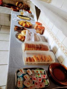 a buffet line with different types of food on it at Pousada Taiwan in Ubatuba +17 photos