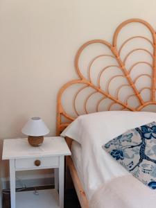 a bed with a wooden headboard next to a night stand at Charzykówka Domek na Kaszubach in Charzykowy