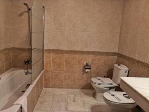 a bathroom with a toilet and a sink and a shower at La Luna Blanca in Torremolinos