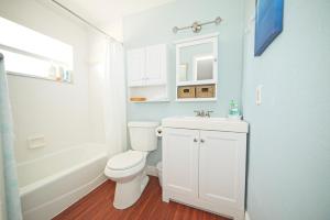 a bathroom with a white toilet and a sink at Cozy Canaveral Beach Condo! Next to NASA Launch Site in Cape Canaveral