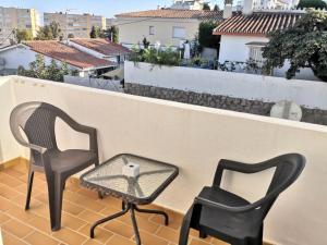 two chairs and a table on a balcony at La Luna Blanca in Torremolinos
