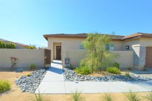 a house with a retaining wall and a driveway at Oasis at Genesis - 30 Day in Palm Desert