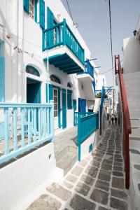 a street in positano with blue and white buildings at Florance Apartments & Rooms in Mikonos