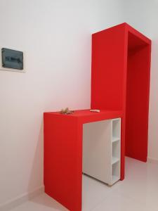 a red desk and a red cabinet in a room at Jz Plus Classio in Rhodes Town