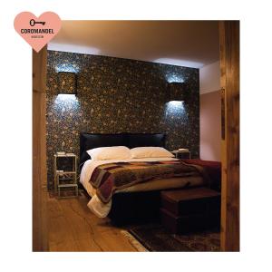 Un pat sau paturi într-o cameră la Maison Coromandel