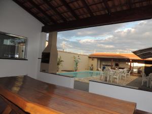 a view from the living room of a house with a pool at Espaço Canastra in Delfinópolis