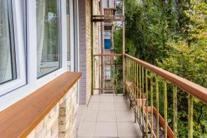 un balcón con un banco de madera en una casa en Уютная квартира на Печерске, en Kiev